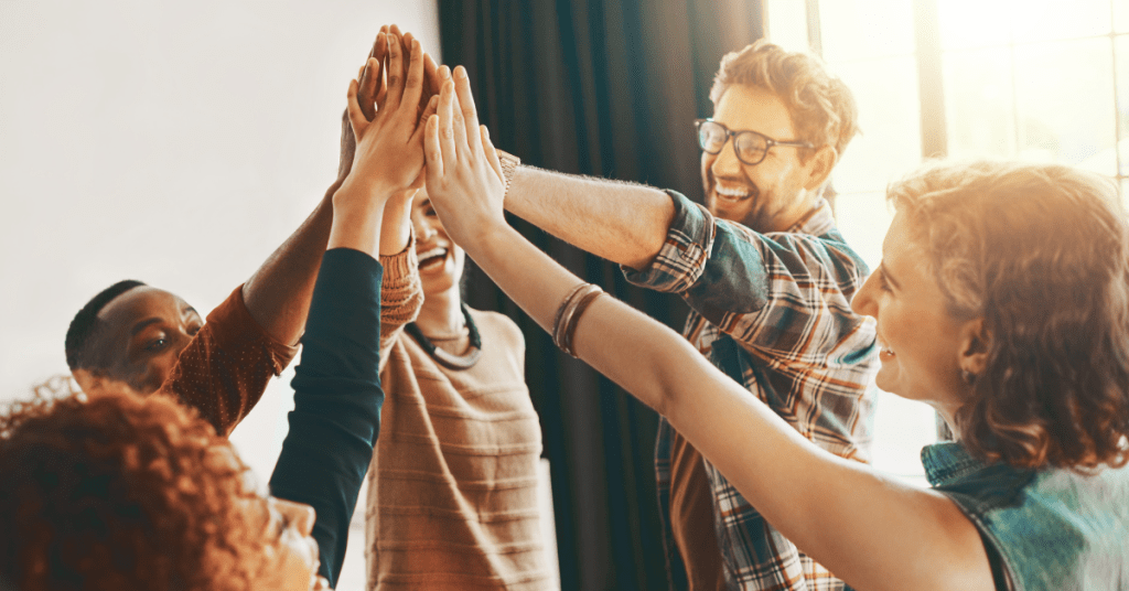 7 Practical Ways to Support Your Nonprofit Team Through Crisis and Beyond team doiing a collective high five